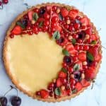 Fresh fruit tart with cream and berries