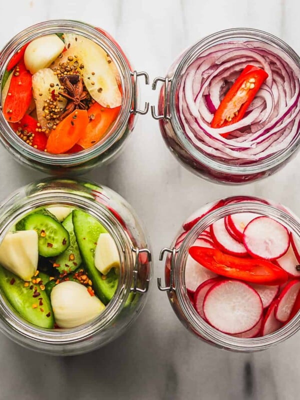 pickled onions, peppers, radish in jars.
