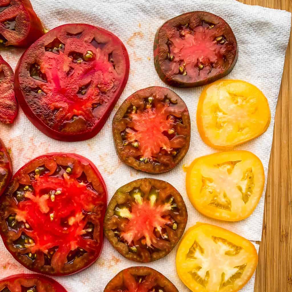 tomato slices draining on paper towel
