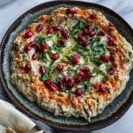 mutabal dip in a plate with pita.