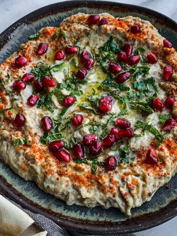 mutabal dip in a plate with pita.