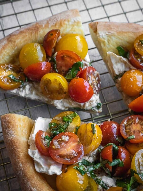 Bruschetta Pizza with burrata and cherry tomatoes sliced.