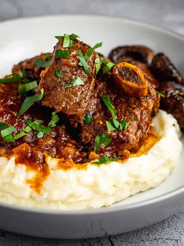 Braised short ribs with mashed potatoes and mushrooms.