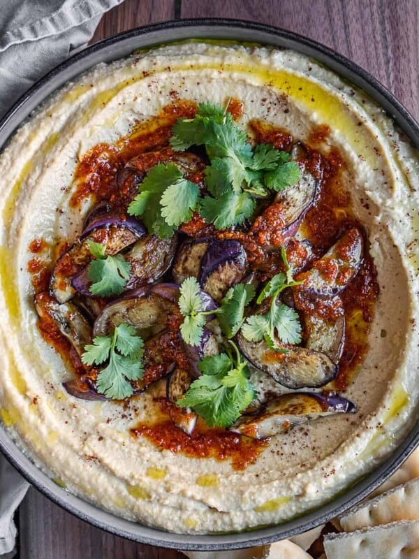 Caramelized eggplant hummus in a bowl with toppings.