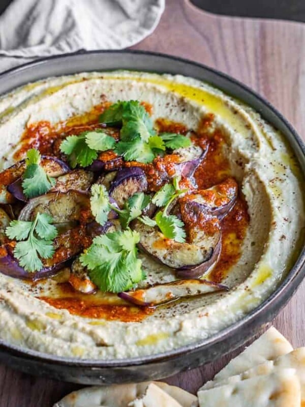 Caramelized eggplant hummus in a bowl with toppings.