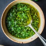Cilantro chimichurri in a bowl with a spoon.