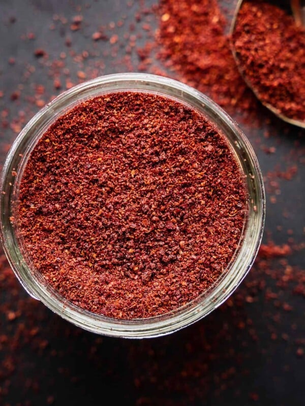 Sumac spice in an open mason jar.