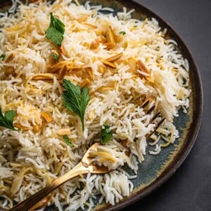 Rice with nuts and parsley on a plate.