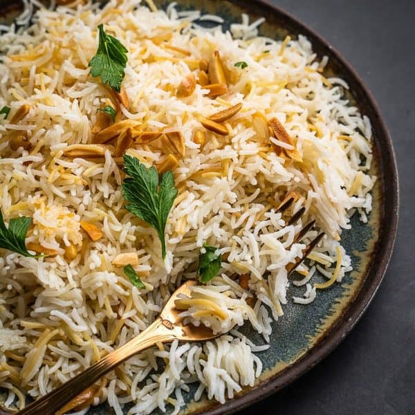 Rice with nuts and parsley on a plate.