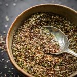 Za'atar spice blend in a bowl with an antique spoon.