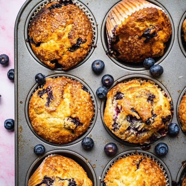 Blueberry and buttermilk muffins in a baking tin.