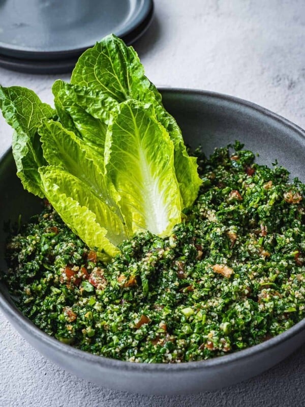 Tabbouleh salad in a bowl with romaine lettuce hearts.