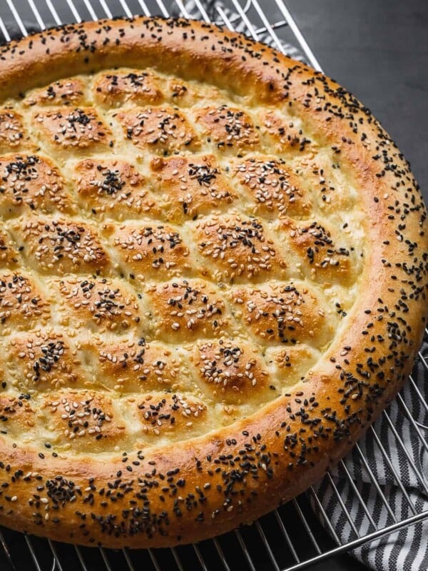 Ramazan pidesi turkish pide bread on a cooling rack.