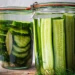 Mason jars packed with cucumbers and spices.