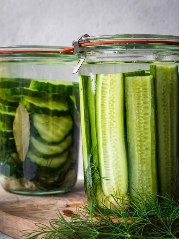 Mason jars packed with cucumbers and spices.