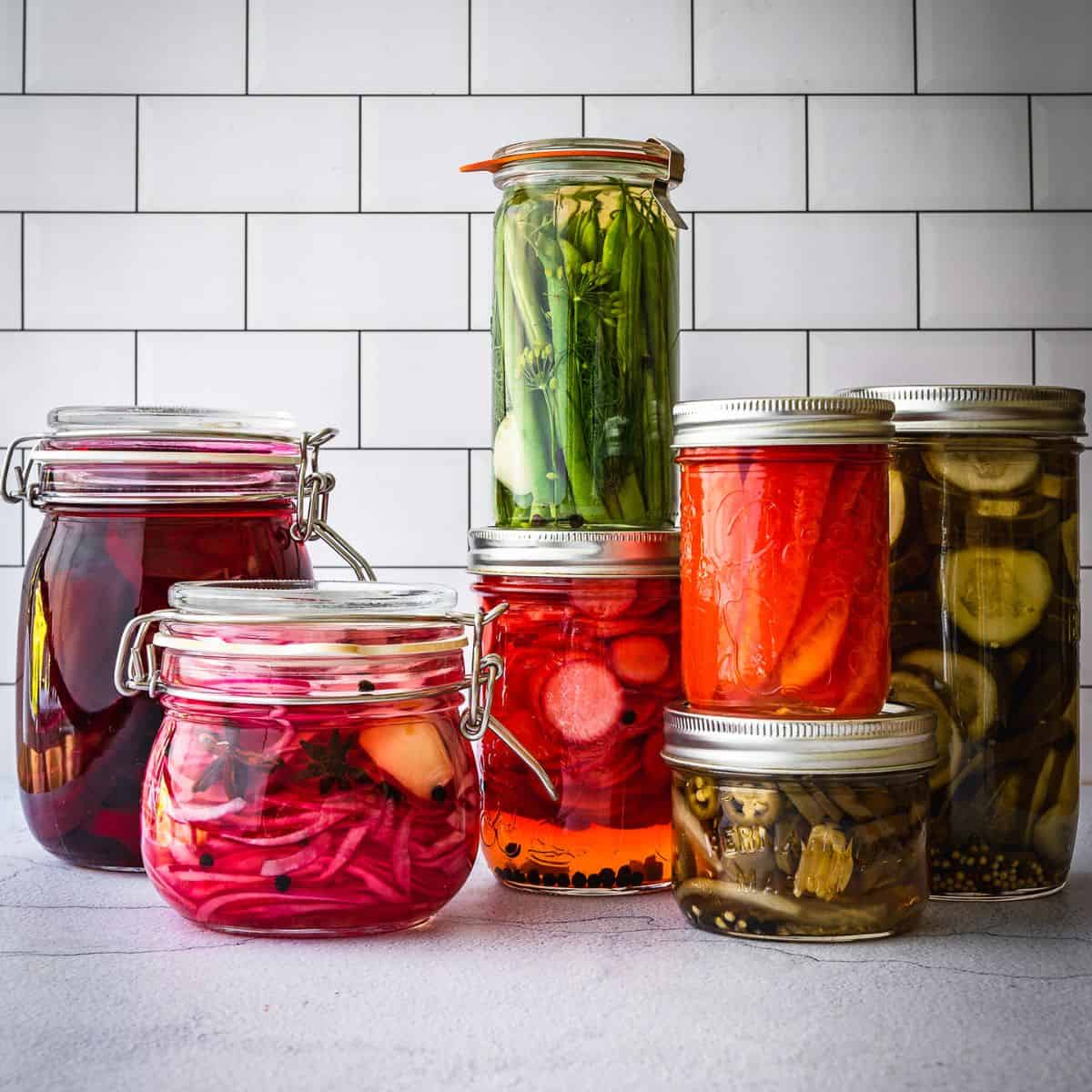Mason jars with pickled vegetables and fruits.