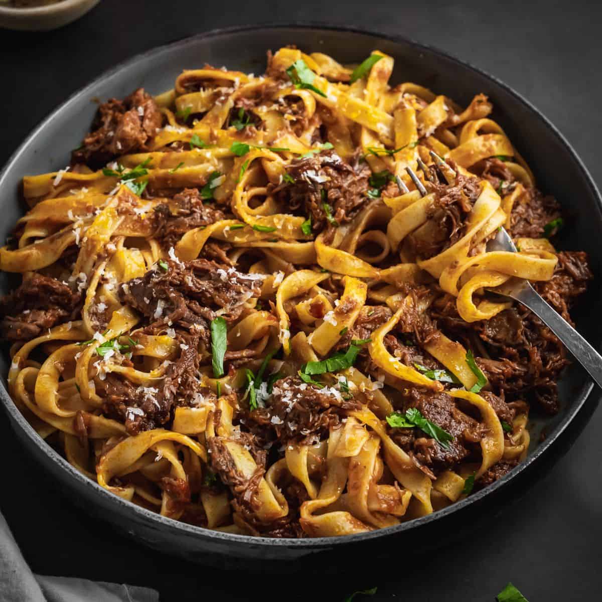 A bowl of beef ragu with pasta.