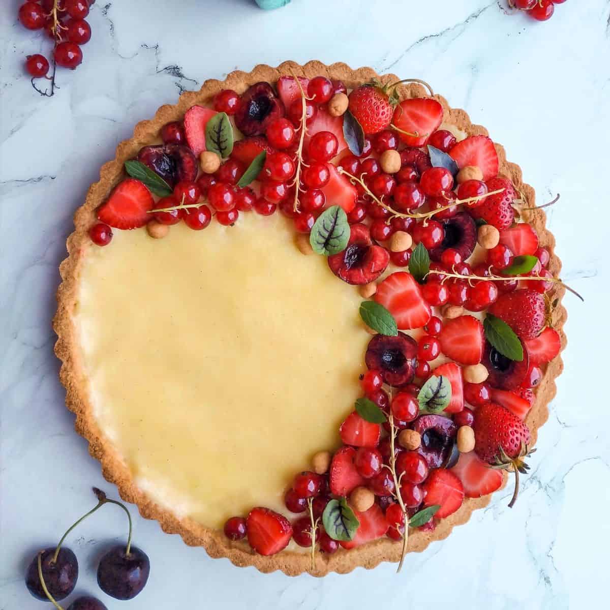 A fresh berry tart with vanilla pastry cream and fresh fruits.