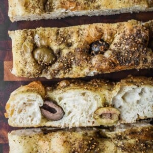 Sliced focaccia with za'atar spice and olives.