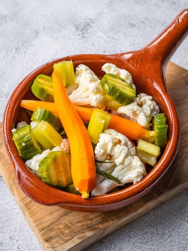 Pickled Italian vegetables in a small crock.
