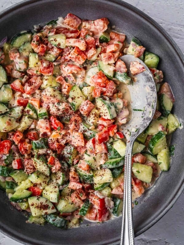 Bowl of tahini chopped salad with sumac garnish.