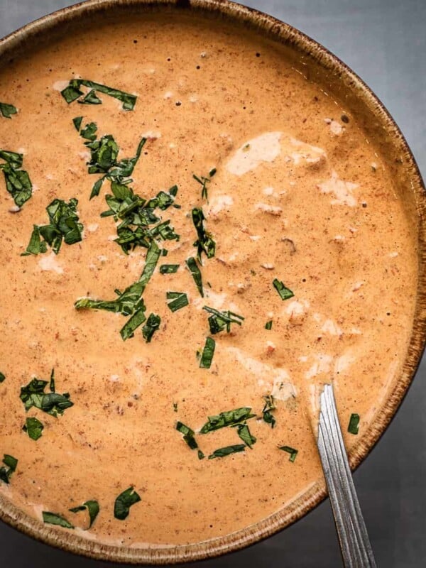A bowl of creamy chipotle sauce garnished with cilantro.