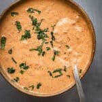 A bowl of creamy chipotle sauce garnished with cilantro.