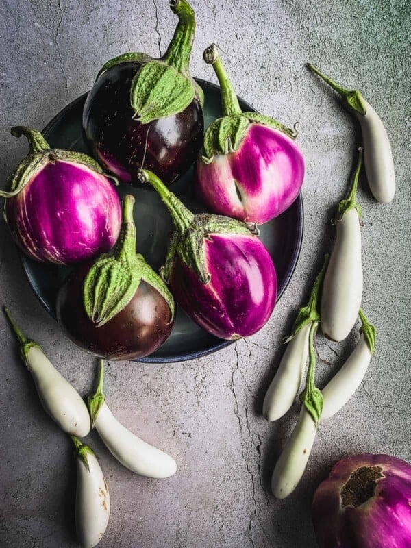 Eggplant varieties in a plate and on a counter.