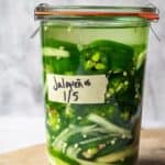 A Weck glass jar with sliced jalapenos and onions.