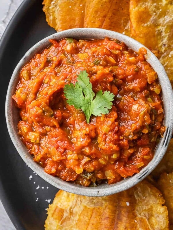 Colombian hogao sauce in a bowl surrounded by fried plantains.