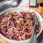 A bowl with sumac onions and parsley.