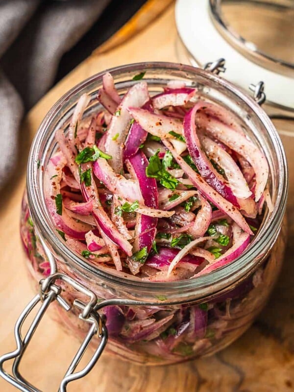 A jar packed with sumac marinated onions.