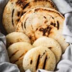 Arepas in a towel-lined basket.