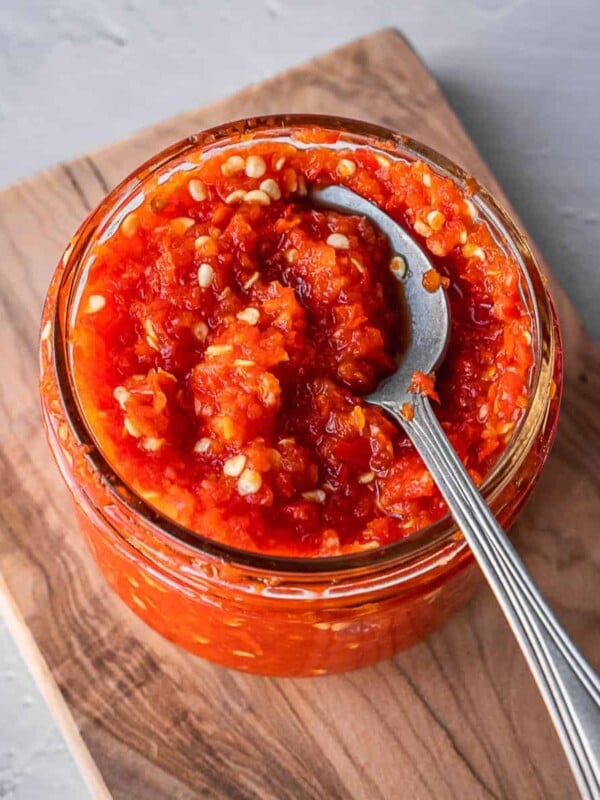 Fermented Sambal Oelek in a mason jar with a spoon.