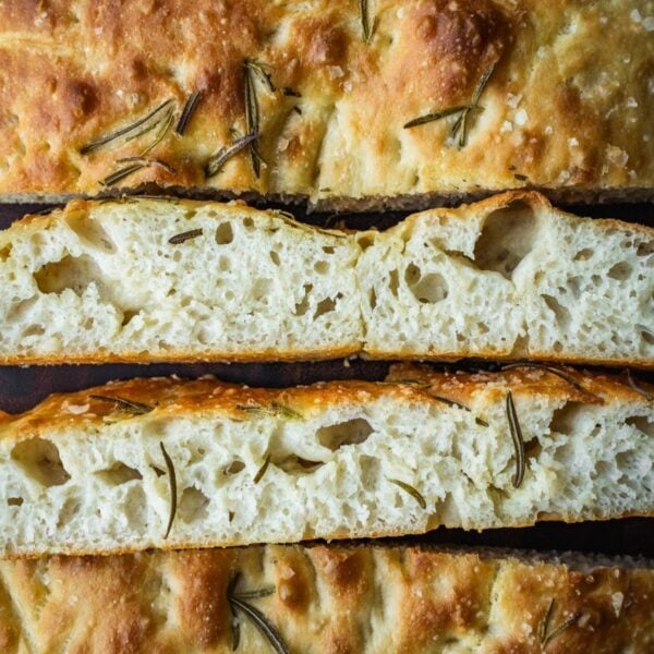 Slices of focaccia on a wire wooden board.