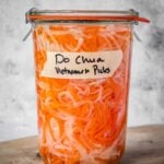 A sealed and labeled jar of do chua, Vietnamese pickled vegetables.