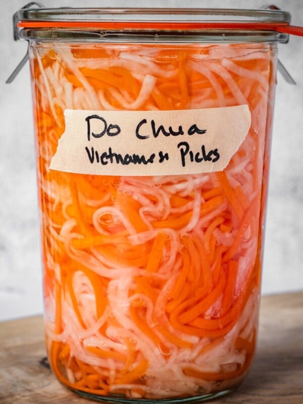 A sealed and labeled jar of do chua, Vietnamese pickled vegetables.