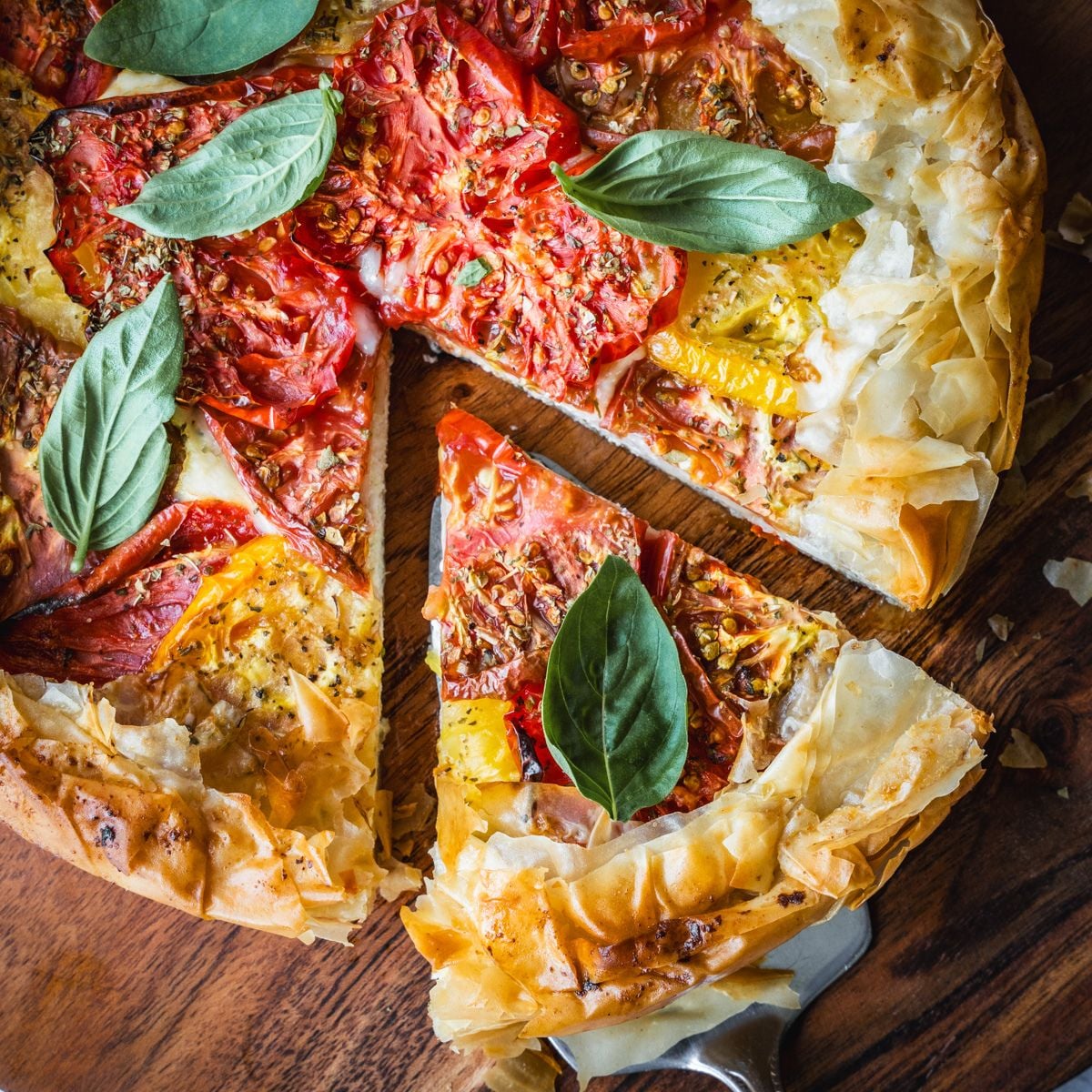 A baked tomato pie with a slice cut out.