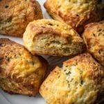Cheddar biscuits piles onto a plate.