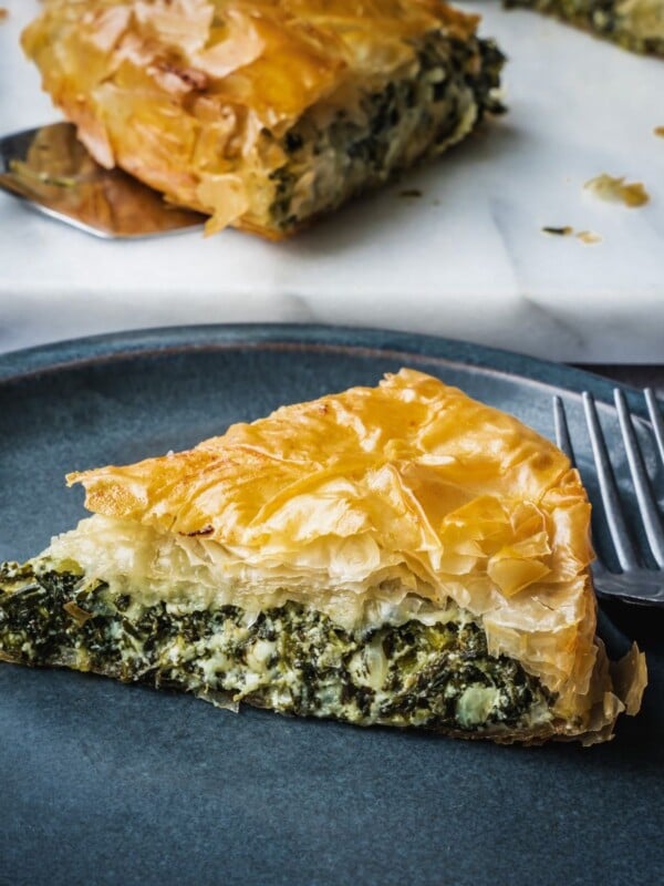 Greek spinach pie slice on a plate.