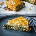 Greek spinach pie slice on a plate.