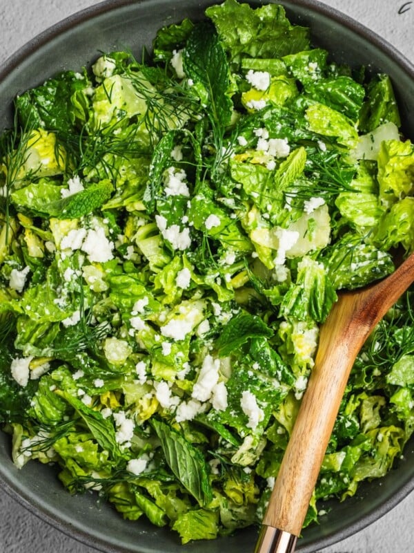 Bowl of Maroulosalata with lettuce, dill, feta and green onions.