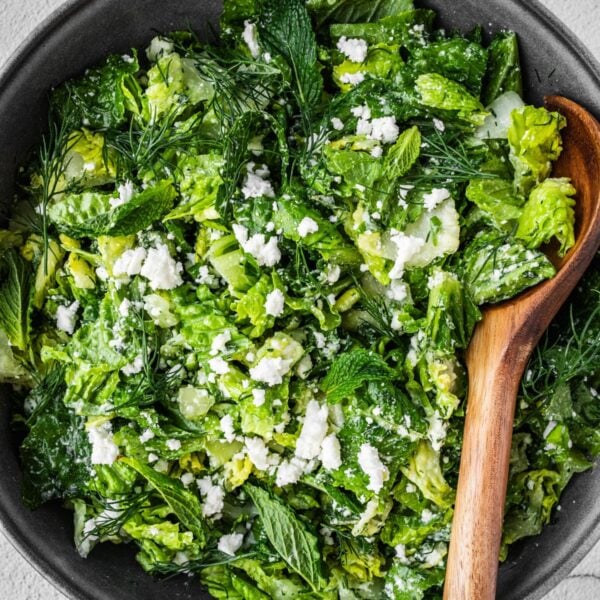 Bowl of Greek Maroulosalata with lettuce, dill, feta and green onions.