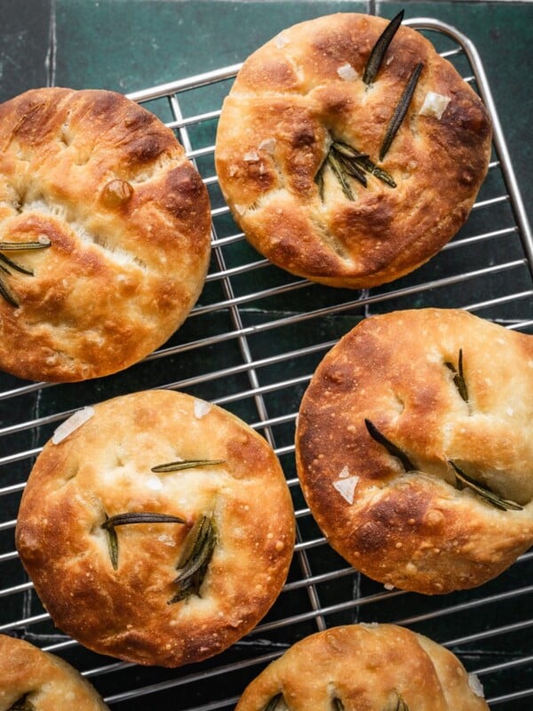Small batch focaccia muffins cooling on a rack.