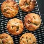 Small batch focaccia muffins cooling on a rack.
