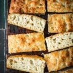 Butter croissant focaccia slices on a board.