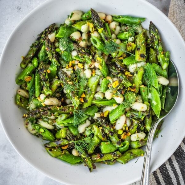 Grilled asparagus and white bean salad in a large bowl.