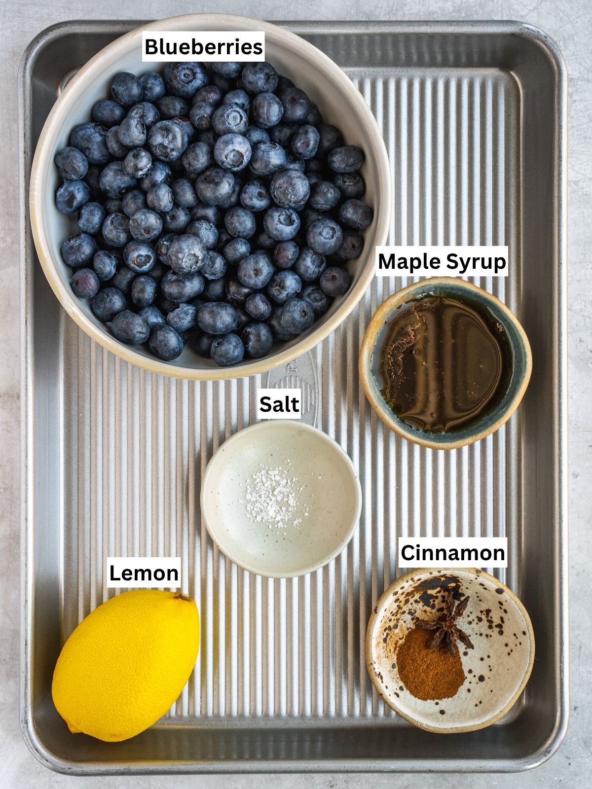 Blueberry Maple Compote recipe ingredients with individual labels on a metal tray.