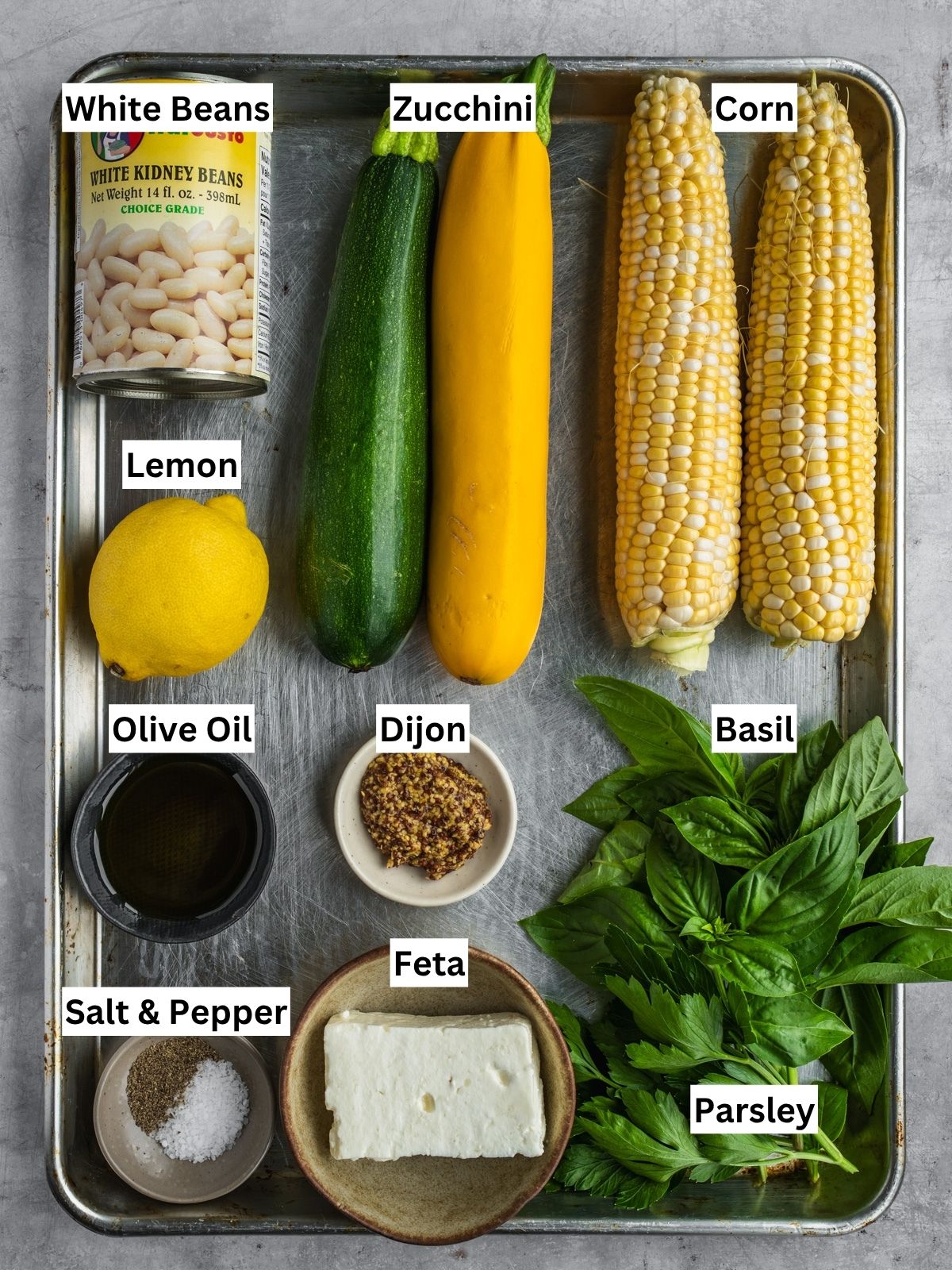 Corn, Zucchini and White Beans recipe ingredients with individual labels on a metal tray.