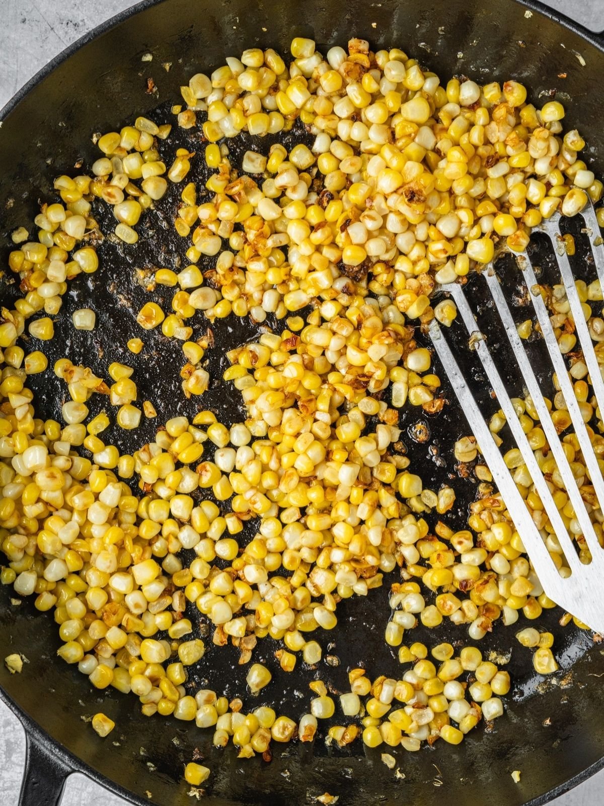 Fresh corn kernels in a sauté pan.